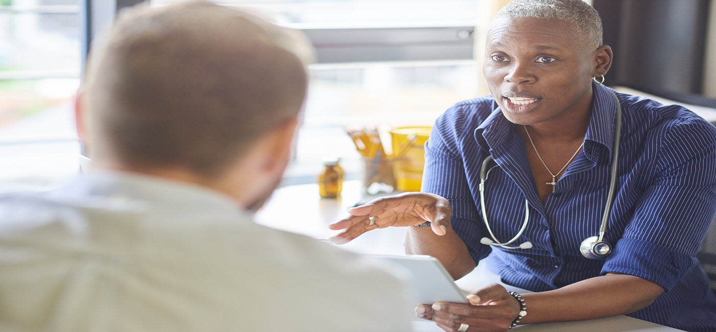 A physician discusses a patient's case with medical students. (©) Blend Images / Alamy).!''